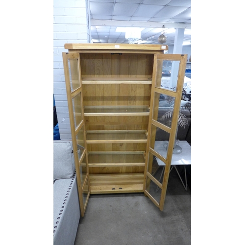 1378 - A Manor oak and glass display unit, missing one glass shelf