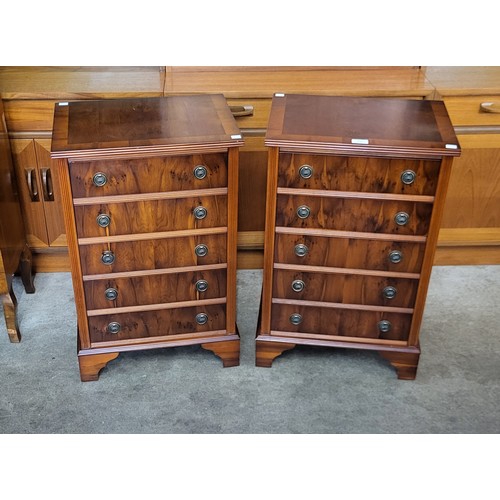 131 - A pair of small yew wood chests of drawers