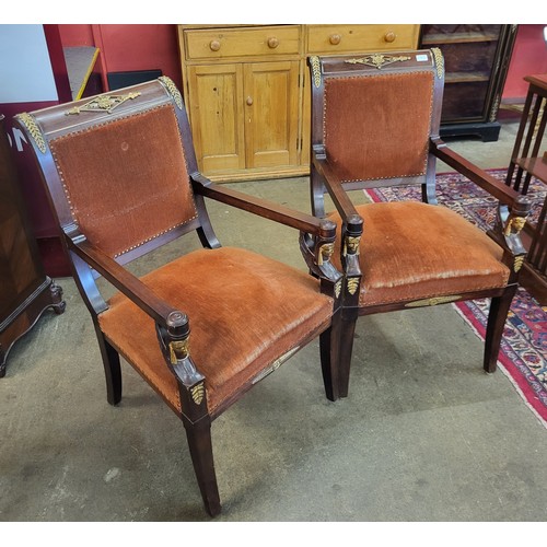 19 - A pair of 19th Century style French Egyptian Revival mahogany and gilt metal mounted fauteuil chairs