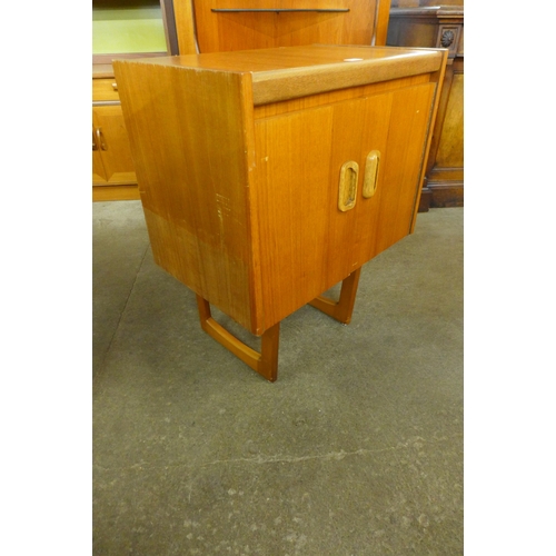 39 - A teak two door cabinet on stand