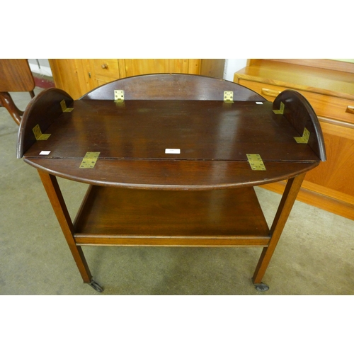 100 - A Victorian style mahogany butlers tray on a stand