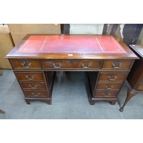 101 - A mahogany and red leather topped pedestal desk