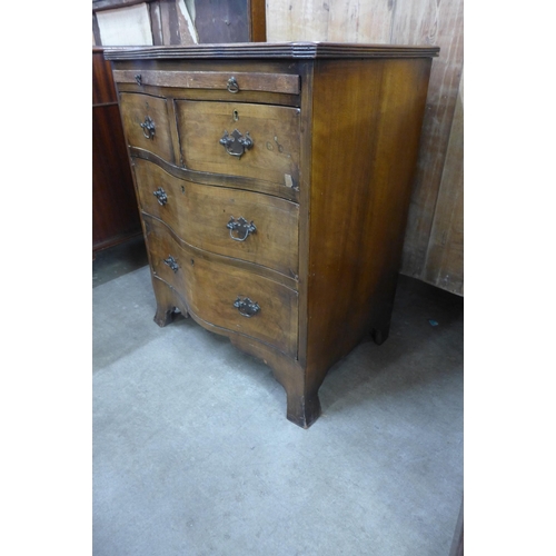 105 - A George III style walnut serpentine bachelors chest of drawers