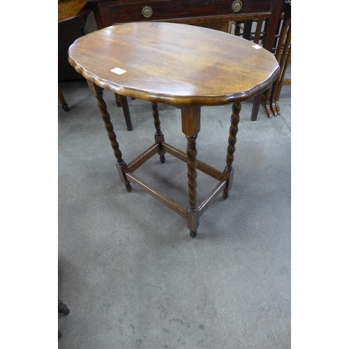 108 - An oak barleytwist oval occasional table