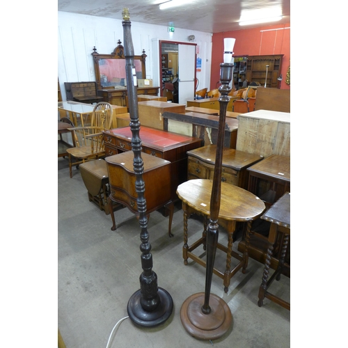 142 - A carved oak standard lamp and a beech standard lamp