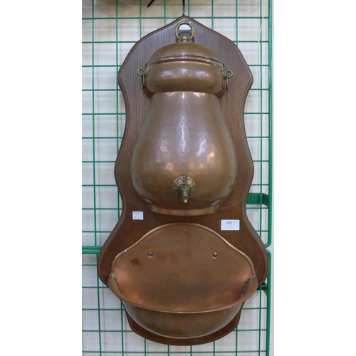 249 - A French oak and copper wall mounted water font