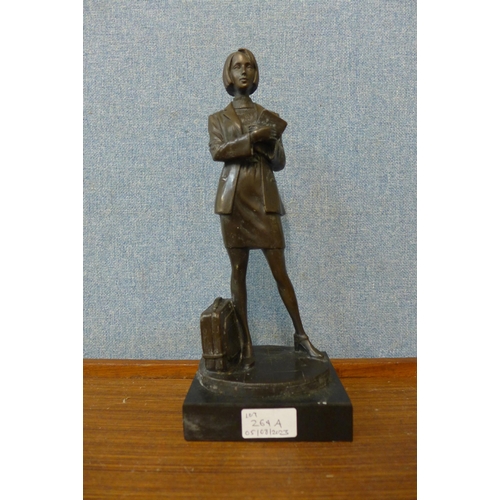 264A - A bronze figure of a lady with suitcase