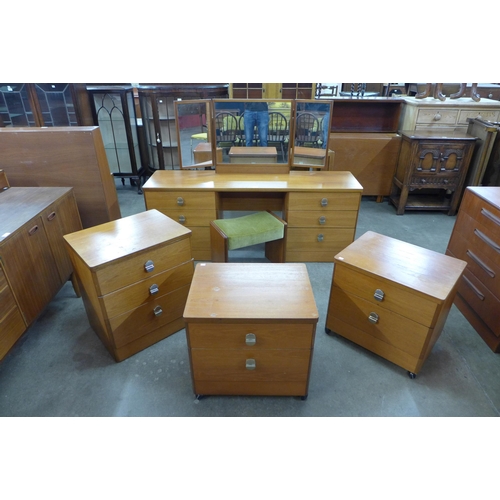 27 - A Stag teak dressing table and stool and three matching bedside chests