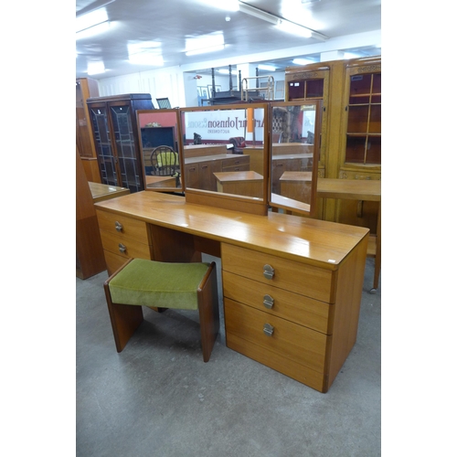 27 - A Stag teak dressing table and stool and three matching bedside chests