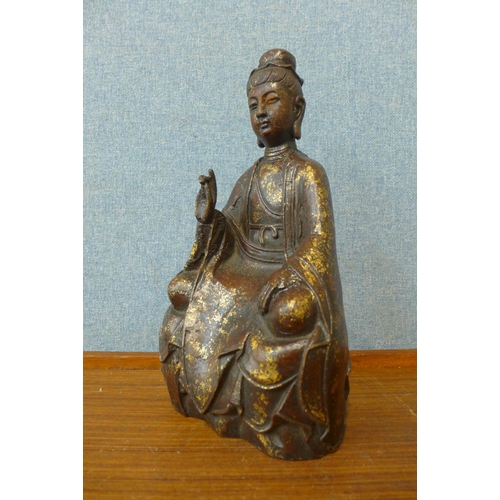 275 - An oriental bronze figure of a seated deity