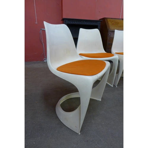 34A - A set of four Danish Cado white perspex chairs, designed by Steen Ostergaard