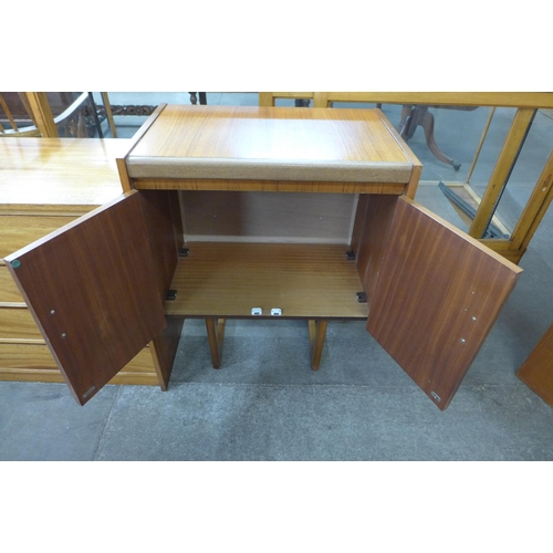 39 - A teak two door cabinet on stand