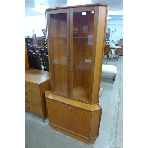 42 - A Turnidge of London teak freestanding corner cabinet