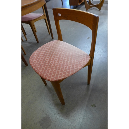 51 - A Nathan teak circular extending dining table and four chairs