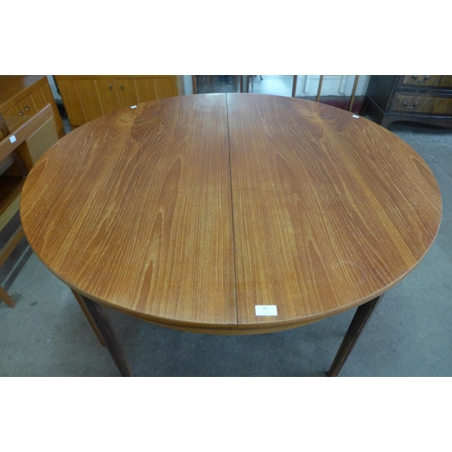 51 - A Nathan teak circular extending dining table and four chairs