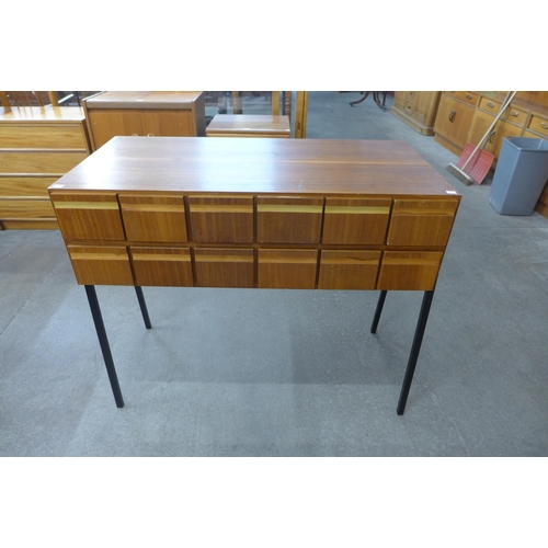 59B - A teak index drawer cabinet on black tubular metal legs