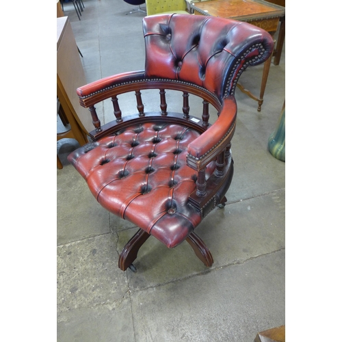 66A - A mahogany and red leather revolving Captain's deck chair