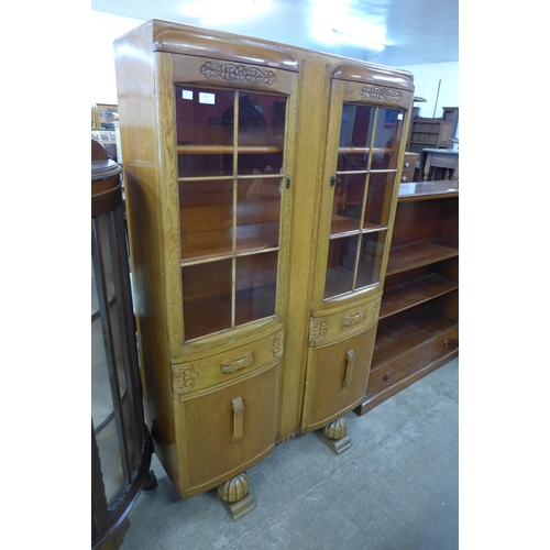 89 - A carved oak four door bookcase