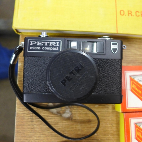 2113 - A Petri Micro Component camera, Olympus OM10 35mm film camera, a Johnson Exactum contact printer and... 