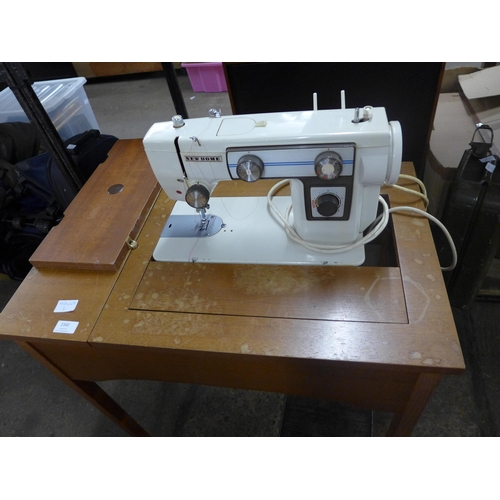 2360 - A New Home sewing machine in cabinet