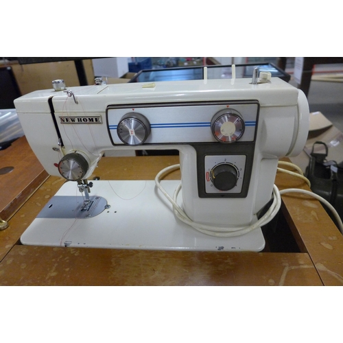 2360 - A New Home sewing machine in cabinet