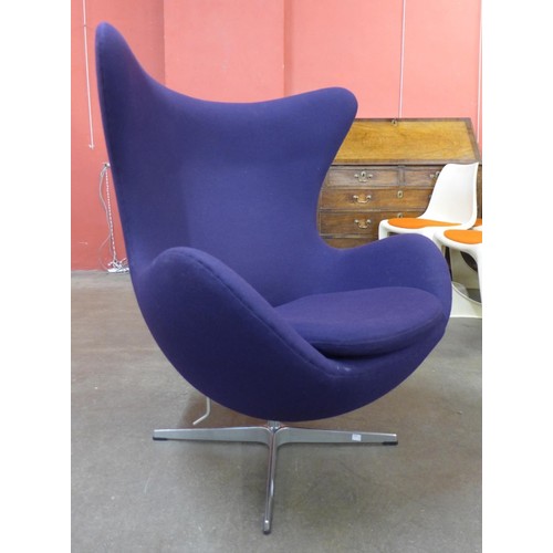 34C - An Arne Jacobsen style chrome and purple fabric revolving lounge chair