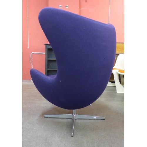 34C - An Arne Jacobsen style chrome and purple fabric revolving lounge chair