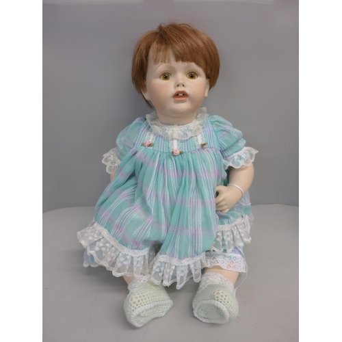 1128 - A modern porcelain doll, marked 1996, Made in Germany **PLEASE NOTE THIS LOT IS NOT ELIGIBLE FOR POS... 