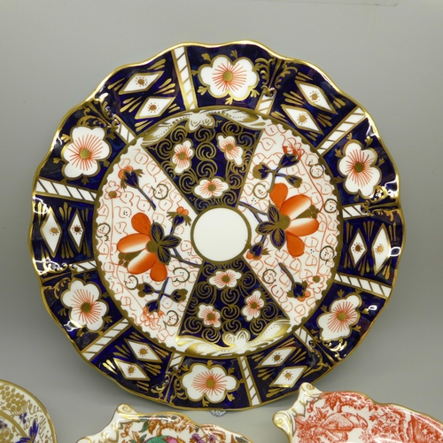 610 - A collection of Royal Crown Derby; seven trinket dishes, a saucer and a 2451 wavy edge side plate