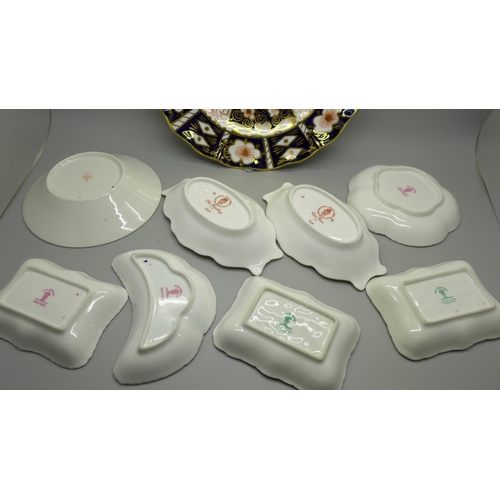 610 - A collection of Royal Crown Derby; seven trinket dishes, a saucer and a 2451 wavy edge side plate