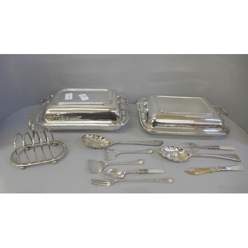 654 - Two silver plated serving dishes, a silver plated toast rack, two berry spoons, etc.