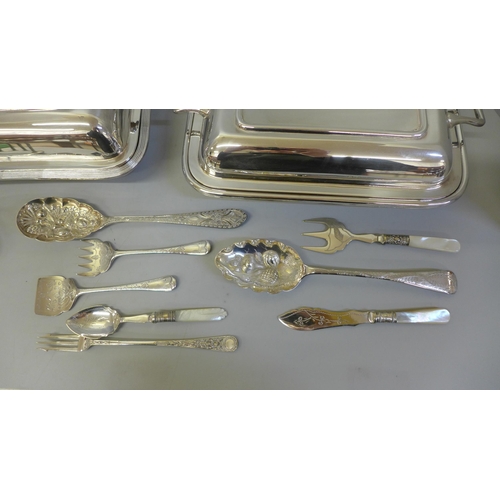 654 - Two silver plated serving dishes, a silver plated toast rack, two berry spoons, etc.