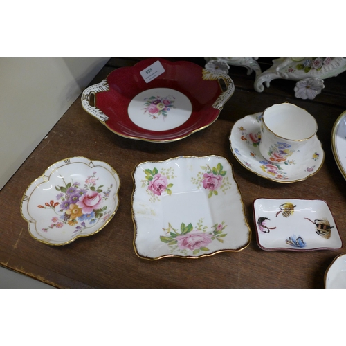 655 - A pair of Victorian spill holders, one repaired, a Minton cup and saucer, a Derby Posies cream jug, ... 