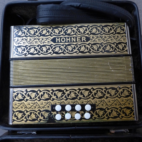 713 - A cased Hohner accordion