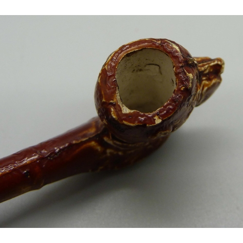 740 - A German child's 19th Century salt glazed stoneware bubble pipe, the bowl in the form of a dog's hea... 