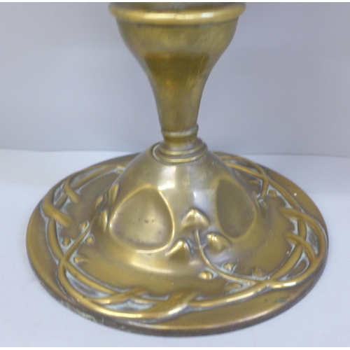 780 - A Victorian or Edwardian Hinks oil lamp with cranberry glass reservoir, on a brass Art Nouveau base