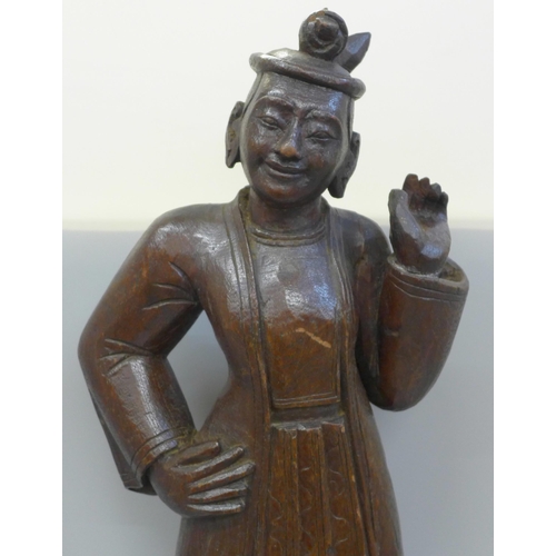 790 - A mid 19th Century oriental wood carving of a figure, probably Burmese, height 57cms