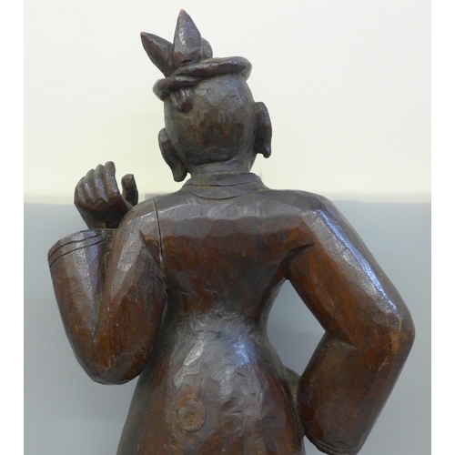 790 - A mid 19th Century oriental wood carving of a figure, probably Burmese, height 57cms