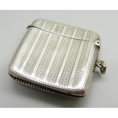 866 - A silver vesta case with applied plaque with tennis scene, engine turned case, Birmingham 1906, 35g