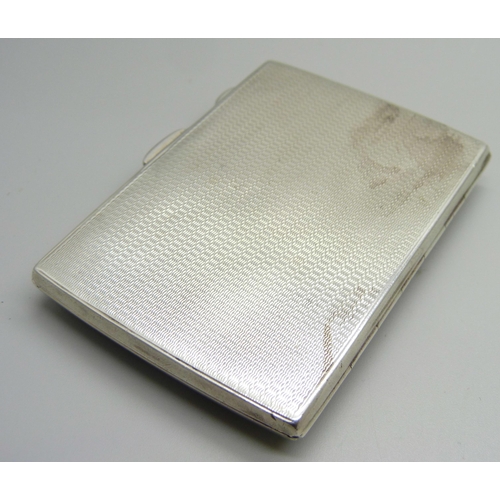 869 - A silver cigarette case with applied plaque, engine turned case, 93g, inner case bears inscription