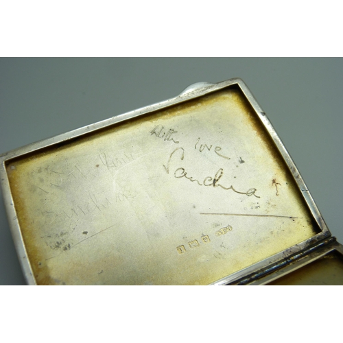 869 - A silver cigarette case with applied plaque, engine turned case, 93g, inner case bears inscription