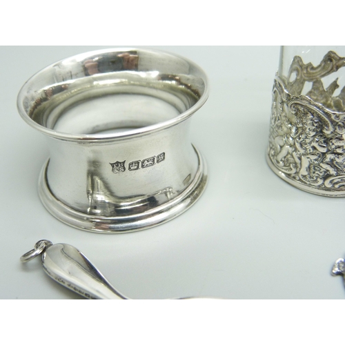 876 - Silver items comprising a small oil lamp, a small enamelled mirror, napkin ring, salt spoons, caddy ... 