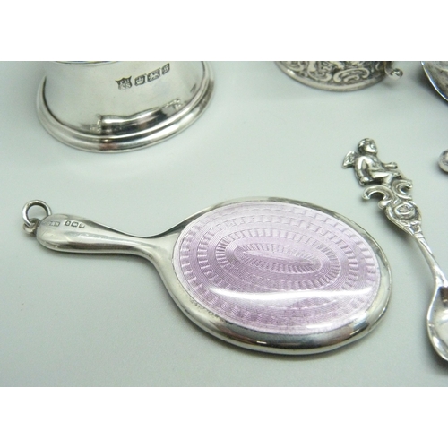 876 - Silver items comprising a small oil lamp, a small enamelled mirror, napkin ring, salt spoons, caddy ... 