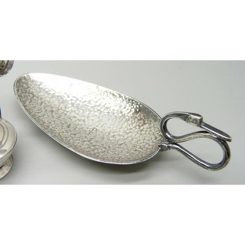 876 - Silver items comprising a small oil lamp, a small enamelled mirror, napkin ring, salt spoons, caddy ... 