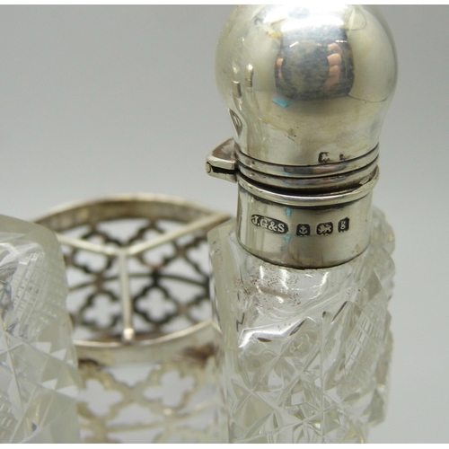 879 - A silver mounted trio of scent bottles in stand, Birmingham 1906