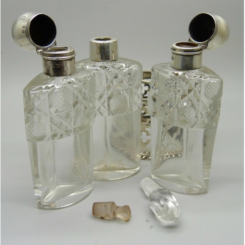 879 - A silver mounted trio of scent bottles in stand, Birmingham 1906