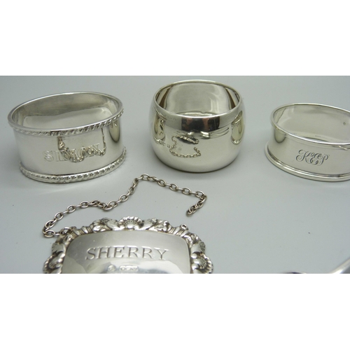 888 - Silver including a Victorian spoon, a caddy spoon and three napkin rings, 135g