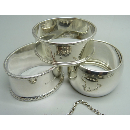 888 - Silver including a Victorian spoon, a caddy spoon and three napkin rings, 135g