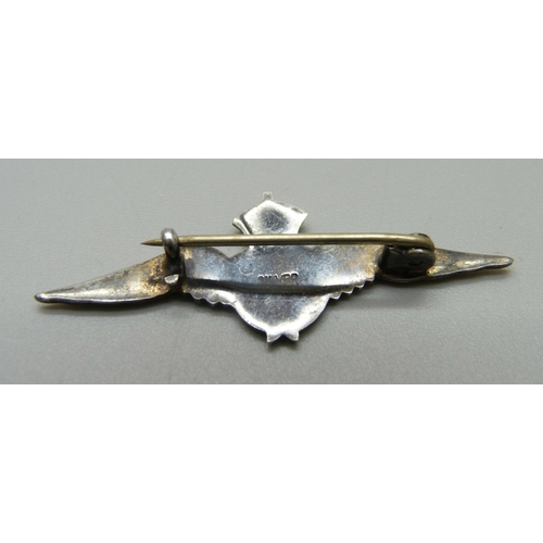 895 - A silver RAF brooch and a trench art lighter made out of two spoons