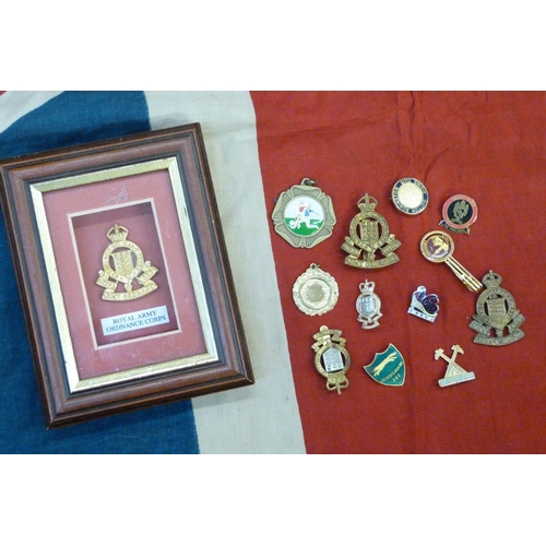 941 - A Union Jack flag, military and other badges including one mounted